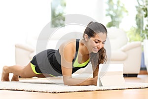 Fitness woman exercising watching fitness videos
