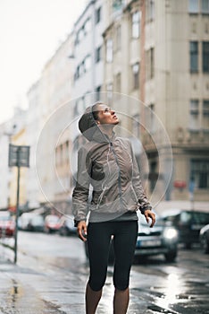 Fitness woman exposed to rain while jogging