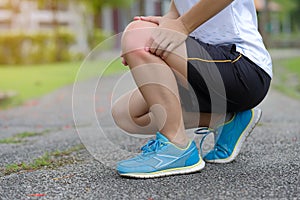 fitness woman holding his sports leg injury, muscle painful during training