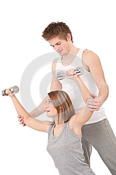 Fitness - Woman with instructor lifting weights