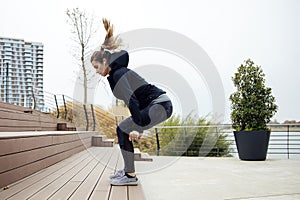 Fitness woman jumping outdoor in urban enviroment