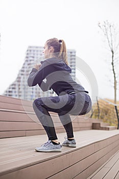 Fitness woman jumping outdoor in urban enviroment by day