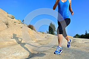 Fitness woman legs running on trail