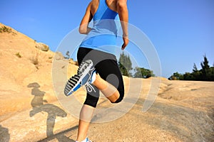 Fitness woman legs running on trail
