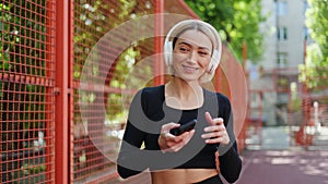 Fitness Woman Listening to Music on Headphones