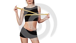 Fitness woman measuring up her chest, isolated on white. Slim body. Girl with measure tape. Copy space. Fitness girl with perfect