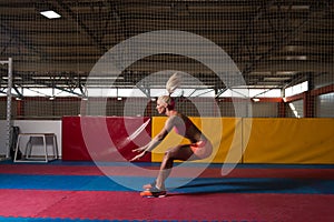 Fitness Woman Performing a Long Jump In Gym