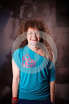 Fitness woman portrait at the gym. Smiling happy female fitness instructor looking at camera.