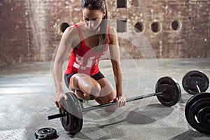 Fitness woman preparing to lift some heavy weights