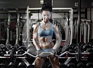 Fitness woman push ups biceps with dumbbell photo