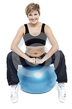 Fitness woman relaxing on exercise ball