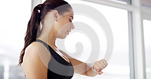 Fitness woman, resistance band and smartwatch success with calorie, goal or workout progress in gym portrait