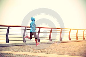 Fitness woman runner athlete running at seaside road