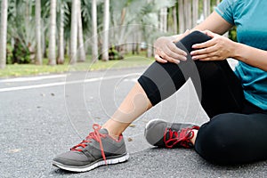 Fitness woman runner feel pain on knee. Outdoor exercise activities concept