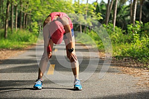 fitness woman runner have a rest during run in forest