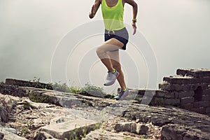 fitness woman runner running on mountain top