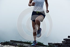 Fitness woman runner running on mountain top