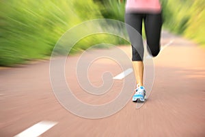 Fitness woman runner running on trail