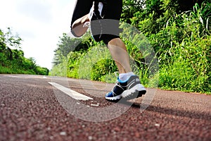 Fitness woman runner running on trail