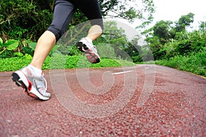 Fitness woman runner running on trail