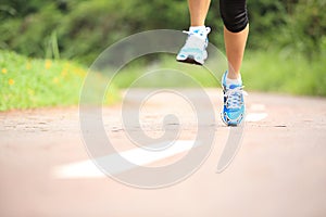 Fitness woman runner running on trail