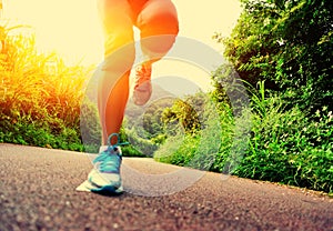 Fitness woman runner running on trail