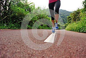 Fitness woman runner running on trail