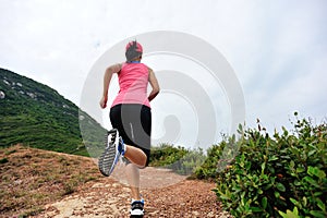 Fitness woman runner running on trail