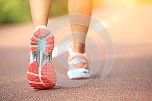 Fitness woman runner running on trail