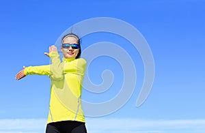 Fitness woman runner stretching arms before running on bea