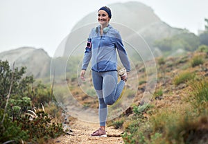Fitness, woman and runner stretching leg for running exercise, workout or training in nature. Active female exercising