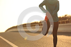 fitness woman runner stretching legs before run