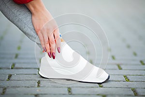 Fitness. Woman Runner Tightening Shoe Lace. Runner Woman Feet Running On Road Closeup On Shoe