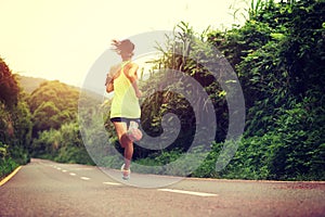 Fitness woman running at forest trail