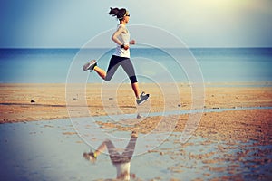 fitness woman running on sandy beach