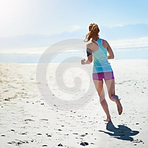 Fitness, woman and running on sandy beach for healthy exercise, workout or cardio training in the outdoors. Active