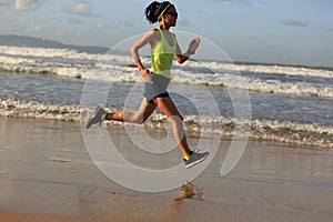 Fitness woman running on sunrise beach