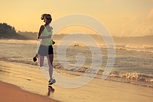 Fitness woman running on sunrise beach