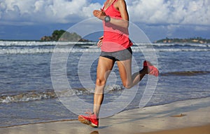 Fitness woman running on sunrise beach