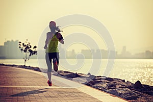 fitness woman running on sunrise coast trail