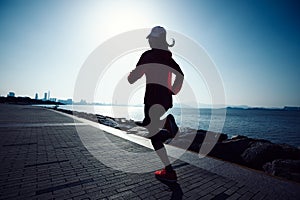 fitness woman running on sunrise seaside