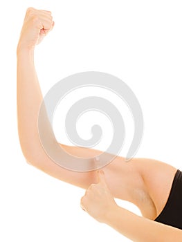 Fitness woman showing energy flexing biceps muscles.