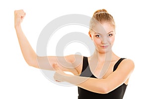 Fitness woman showing energy flexing biceps muscles.