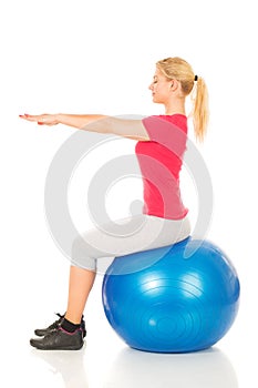 Fitness woman sitting on pilates ball