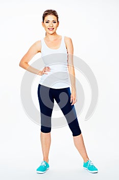 Fitness woman in sport style standing against white background