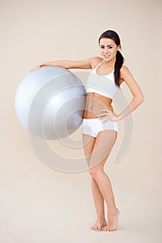 Fitness woman standing with gym ball