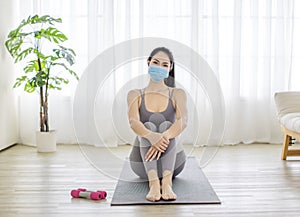 Fitness woman streching Relaxing after training and wearing  protectve face mask during Covid 19 photo