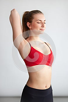 Fitness woman stretching arms back