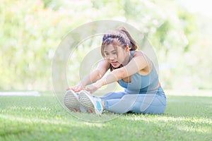 Fitness woman stretching muscles before sport activity, Young sportswoman stretching and preparing to run in park