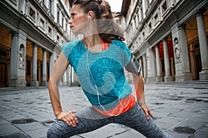 Fitness woman stretching near uffizi gallery in florence, italy